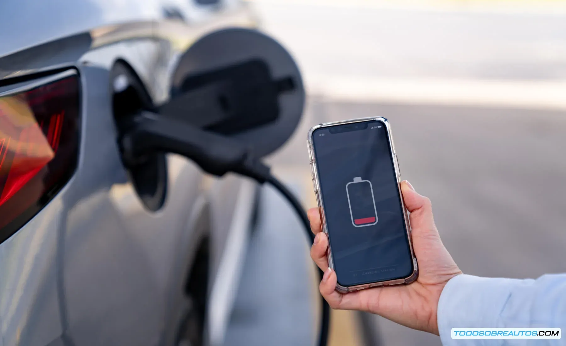 Conductor utilizando su teléfono móvil para solicitar asistencia en carretera durante un apagón.