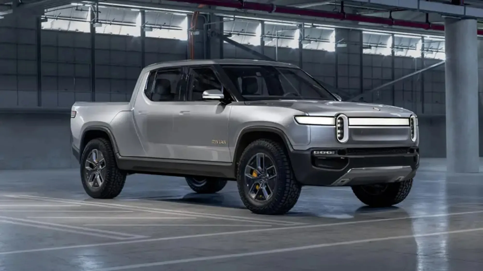 Rivian R1T Una pick-up eléctrica de diseño robusto y moderno en color plateado.