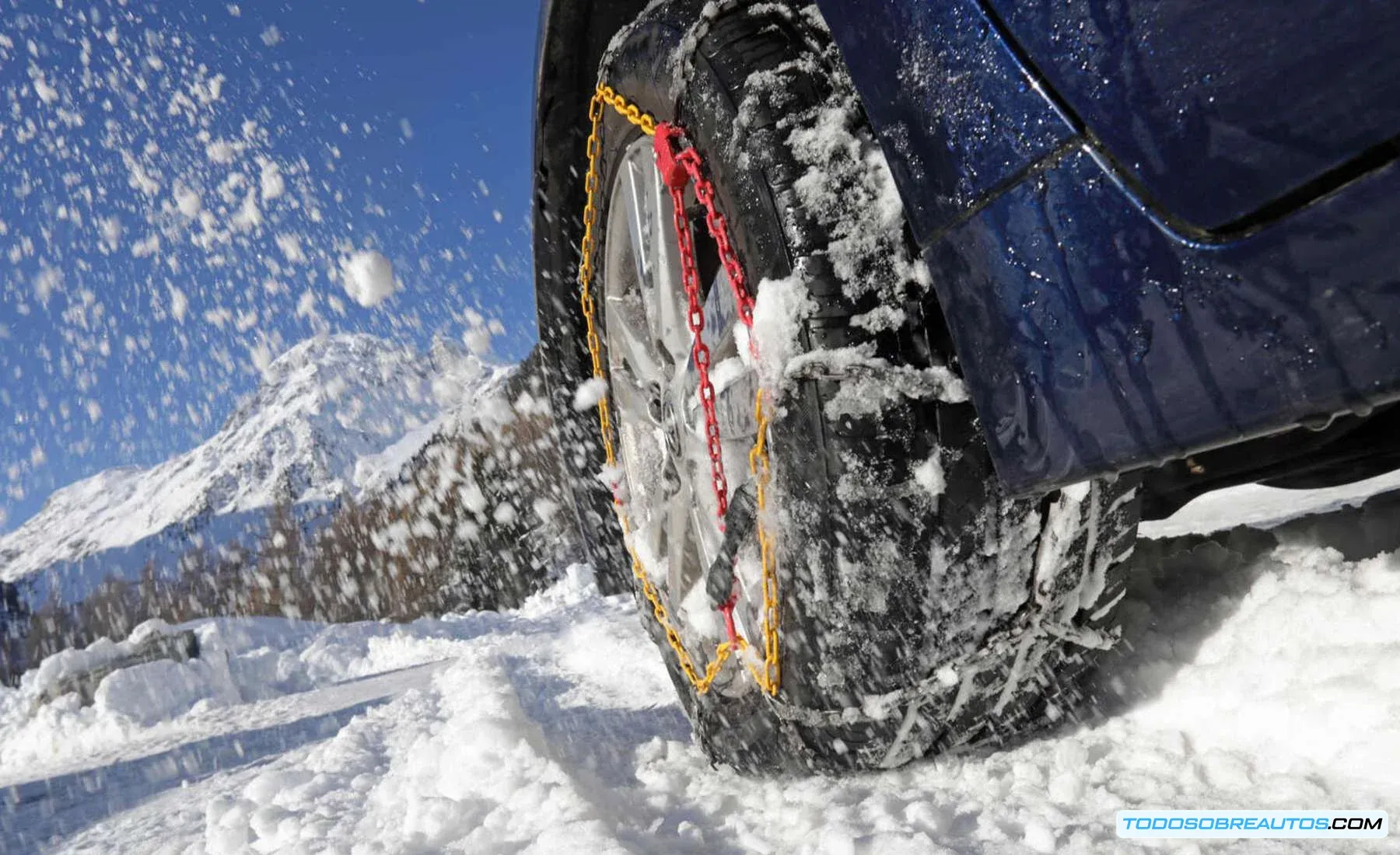 Coche circulando con cadenas de nieve en movimiento.