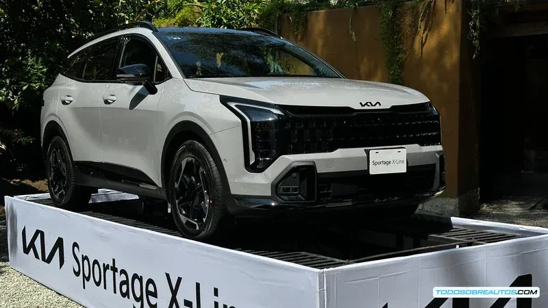 Coches eléctricos cargándose en una estación de carga con un paisaje urbano de fondo.